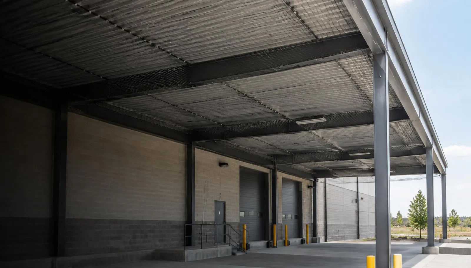Bird exclusion netting protecting a commercial loading dock canopy